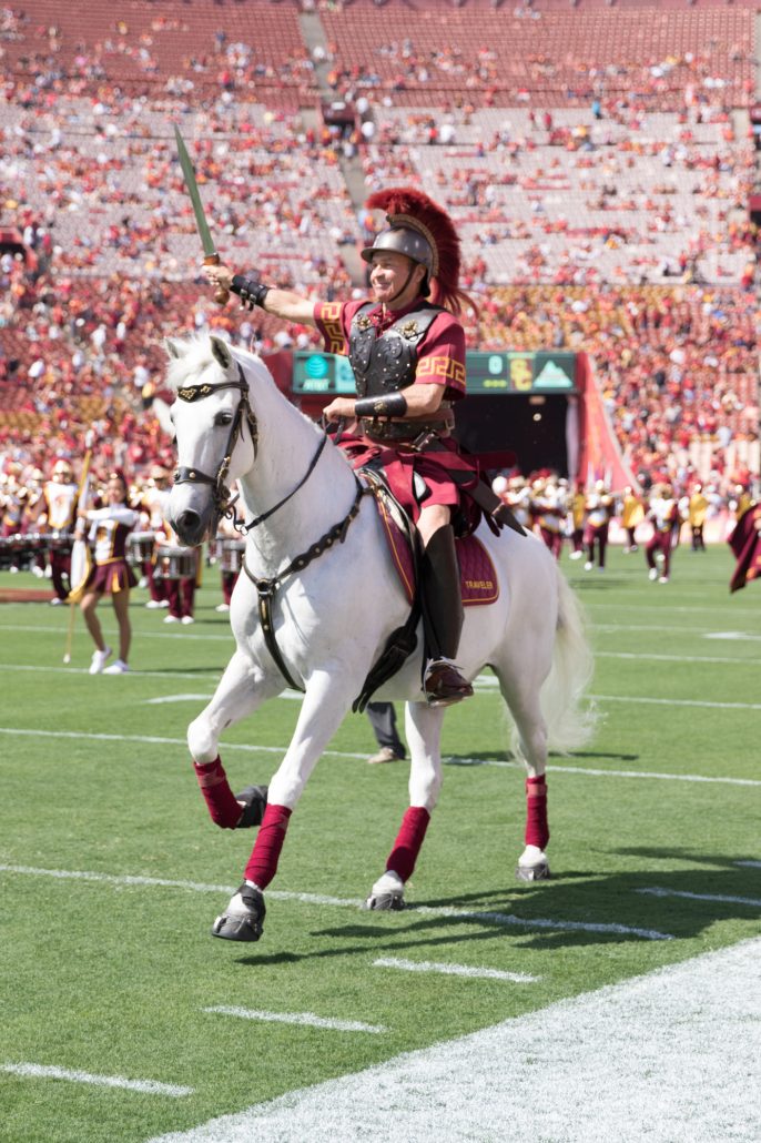 Nick Entin | Daily Trojan Traveler, ridden by Hector Aguilar, gallops around the field prior to kickoff. 