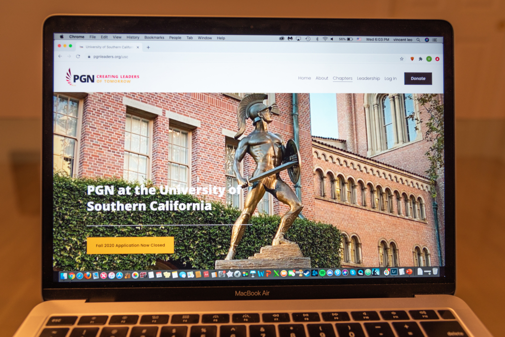 A laptop with the PGN website showing a photo of Tommy trojan