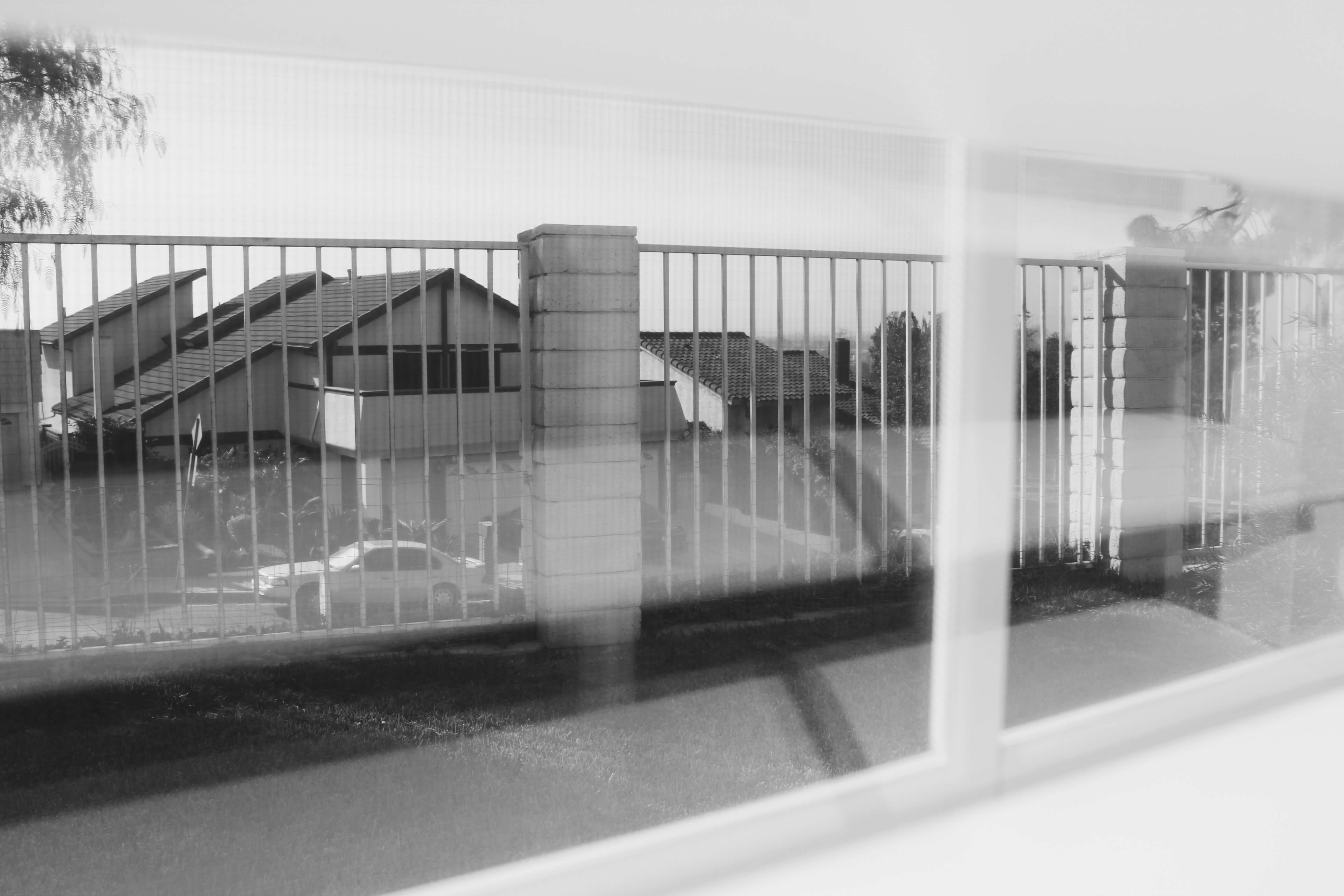 Black and white photo of the street from inside a window