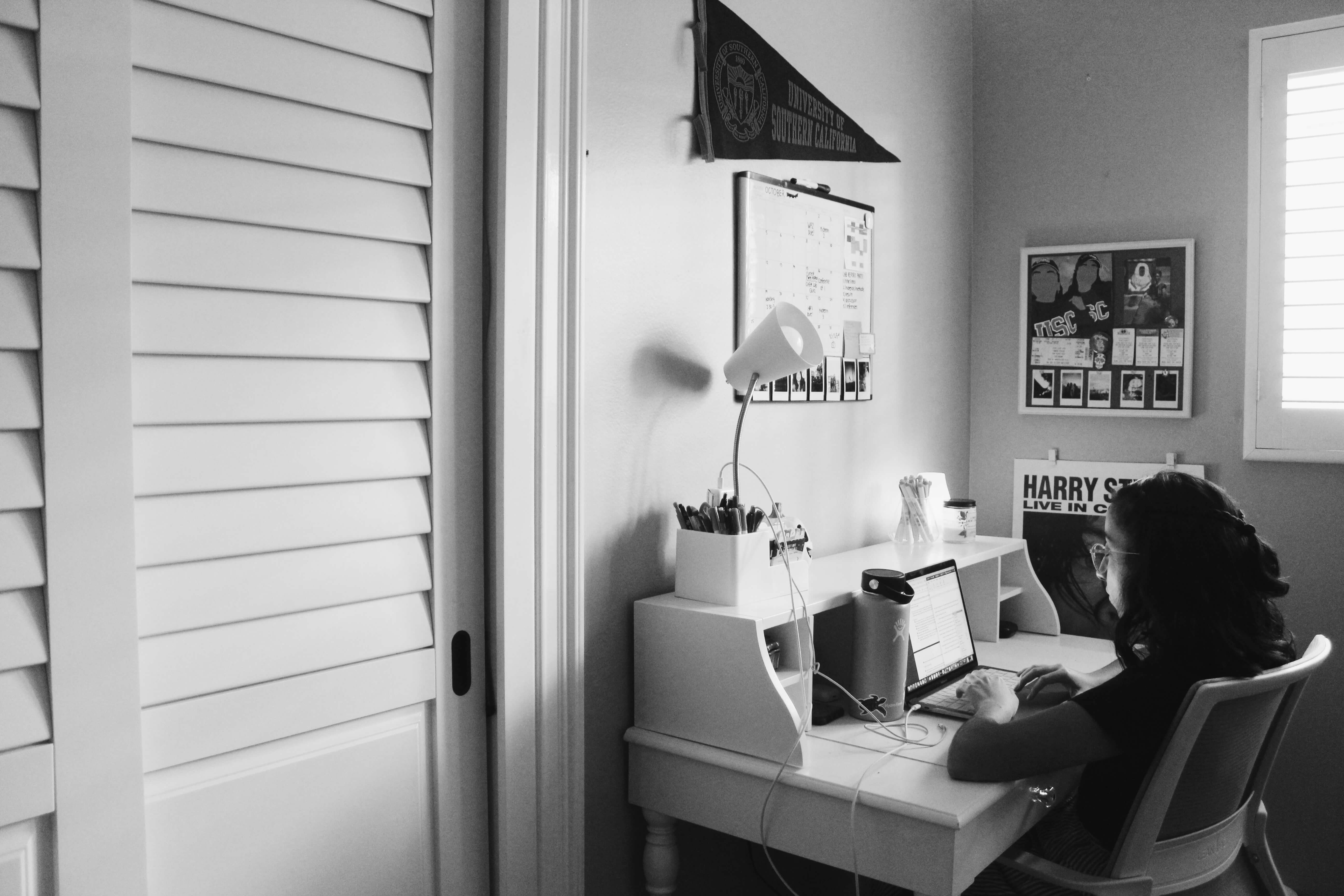 Black and white photo of a person studying in room