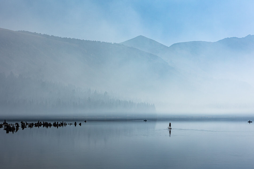 Lake under blue sky and mist