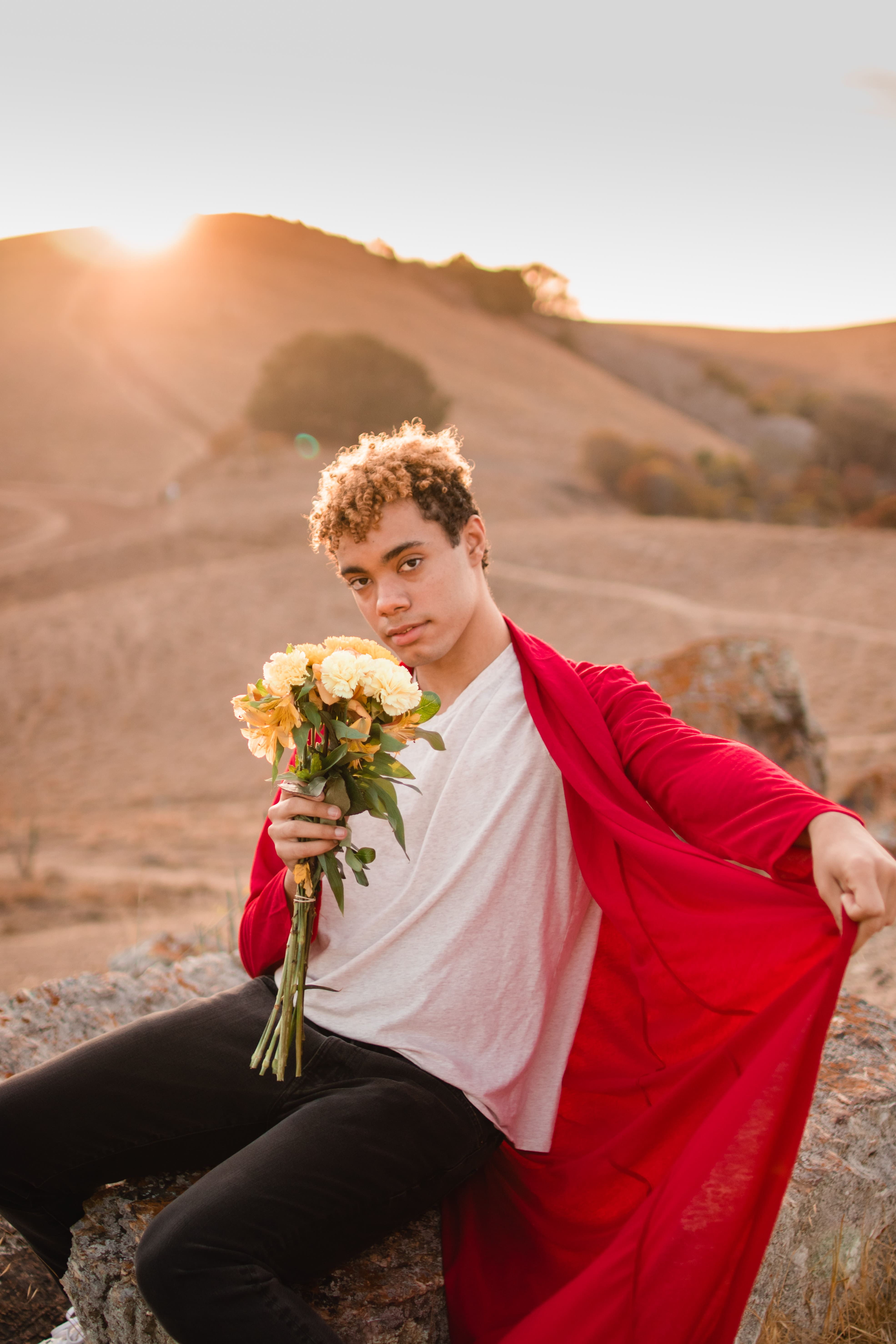 Person holding yellow flowers