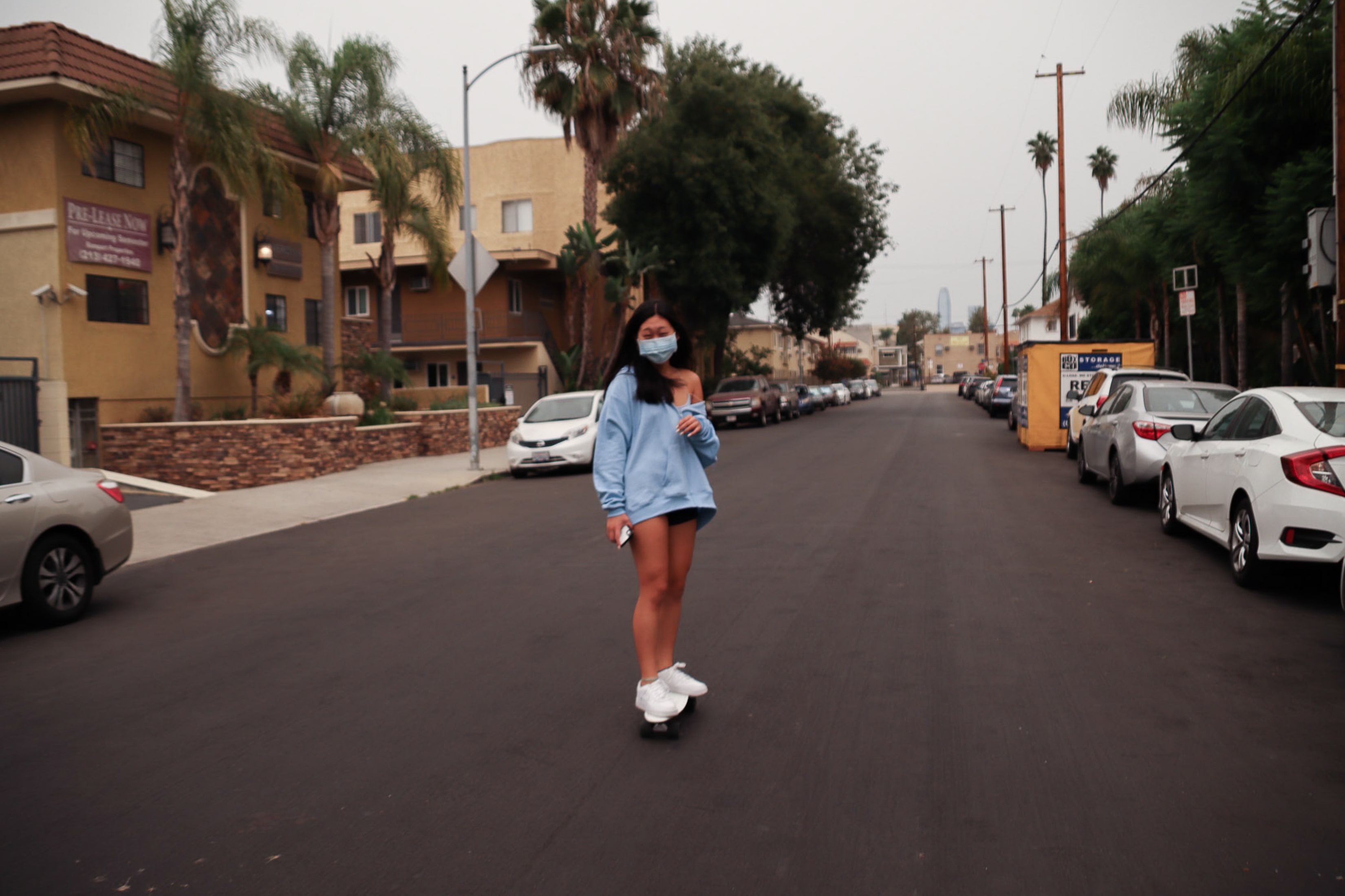 Person skateboarding down empty street