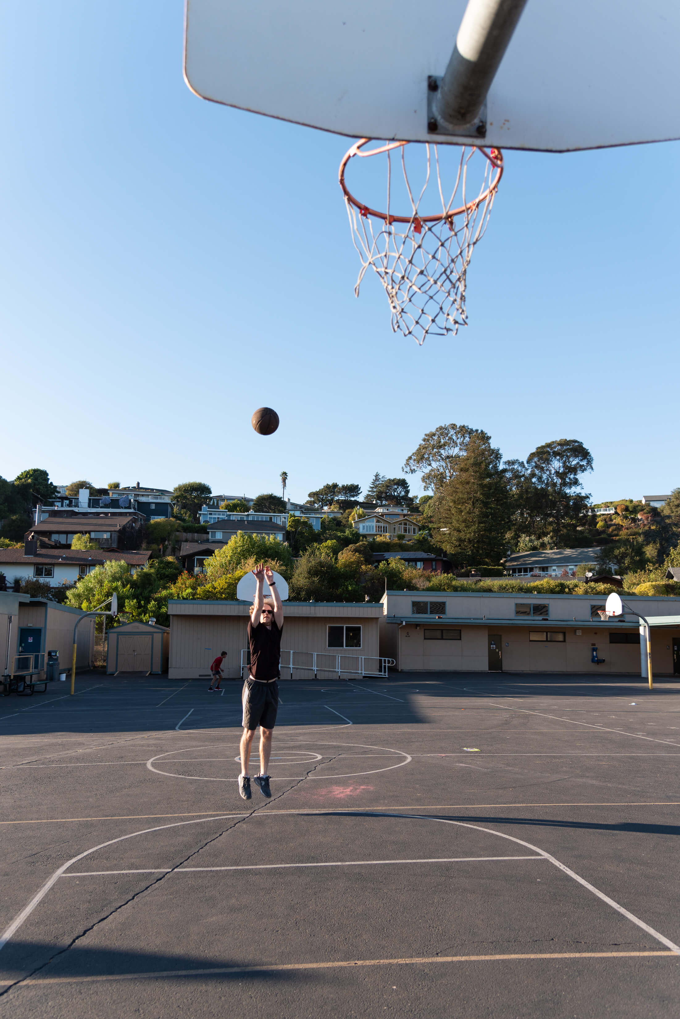 Person shooting basketball into hoop
