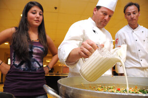 Got milk? · Sarah Kelly (left), a freshman majoring in cinema-television production, looks on as Thomas Moran (center),  associate executive chef at USC, cooks a vegetarian dish at EVK Wednesday. The demonstration was part of an initiative that aims to increase the availability of vegetarian options. - Young Kim | Daily Trojan