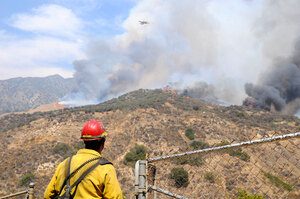 Ablaze · A firefighter looks out over the Station fire, which has been raging through northeast Los Angeles since Wednesday. The fire has burned more than 35,000 acres, threatening 10,000 homes in towns near Los Angeles and forcing evacuations. - Eric Wolfe | Daily Trojan