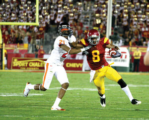 Welcome home · USC junior receiver Ronald Johnson stiff arms Oregon State cornerback Tim Clark after one of his nine catches Saturday. In just his second game of the season since coming back from injury, Johnson led USC with 99 yards receiving. - Tim Tran | Daily Trojan