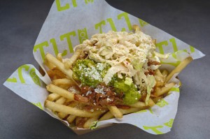 Not so small fries · TLT Food’s shareable appetizers bring bold combinations of flavors to the forefront. The carnitas fries (pictured above) include carnitas slow-cooked for 12 hours and topped with a dollop of guacamole.  - Courtesy of Entertainment Fusion Group 