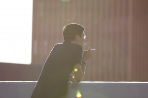 Light ’em up · A USC student takes a break to smoke a cigarette across from Waite Phillips Hall on campus. USC researchers received a grant from the Food and Drug Administration to research the effects of smoking. tobacco. - Photo Illustration by Nick Entin  