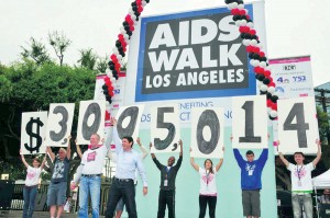 Fighting the good fight · Participants in the 2012 AIDS Walk Los Angeles hold up numbers signifying the total amount of funds raised. The organization has raised more than $1.7 million towards the effort from online donations this year, with more anticipated from private donors. - Courtesy of L.A. Aids Walk 