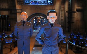 The young commander · British actor Asa Butterfield (right) stars as Andrew Wiggin in Ender’s Game, the new film adaptation of Orson Scott Card’s 1985 science fiction novel of the same name. The film is set in 2086, when an alien race attacks Earth and threatens its existence. - Photo courtesy of Lionsgate Films 