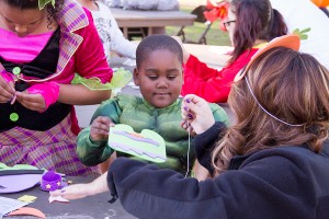 Getting scary · A 4-year-old boy prepares for Halloween festivities by creating a mask with the help of a USC student on Thursday afternoon. - Austin Vogel | Daily Trojan 