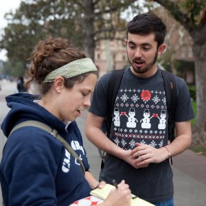 Activism ·  Junior Matthew Shoemaker (right), a member of SCALE, talks with Leanne Tracy (left), a missionary, as she signs the petition. - Ralf Cheung | Daily Trojan 