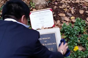 Remembrance · The father of Ming Qu, one of the two Chinese graduate students killed off-campus in April 2012, look’s over the memorial of his son and Yings Wu near the Viterbi School of Engineering. A tree was planted in honor of the students’ deaths at the memorial site. - Courtesy of Daniel Deng 