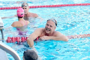 Just keep swimming · Olympian John Naber shakes the hand of a fellow relay participant during the 34th annual Swim with Mike swim-a-thon, which took place at the Uytengsu Aquatics Center on April 5. - Kirstin Louie | Daily Trojan 