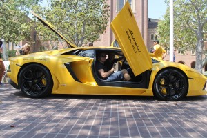 Vroom vroom · Aaron Bajor (front), president of the USC Auto Club, and Ryan McLean (back), secretary of the USC Auto Club, strike a pose in a Lamborghini, one of the cars on display during Sunday’s event. - Paul Jung | Daily Trojan 