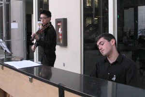 Remember, Unite, Renew · William Liao (left), a junior majoring in health promotion and disease prevention and biological sciences, and Alex Biniaz-Harris (right), a junior majoring in business administration and music, perform at the vigil on April 7. - Christine Yoo | Daily Trojan 