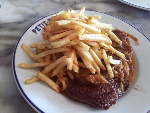 Big steaks · The steak-frites at Petit Trois are exactingly prepared. A large ribeye is cooked to a flawless medium rare, topped with an onion soup sauce and accompanied with french fries cooked in beef tallow. - Uracha Chaiyapinunt | Daily Trojan 