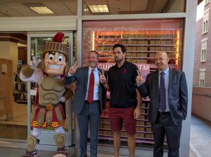 Allen Pham | Daily Trojan Sweet stuff · Former USC starting quarterback Matt Leinart (center-right) poses with USC Hospitality staff at the opening of the Sprinkles ATM at the Pertusati Bookstore Monday. The machine is the result of months of work by USC Hospitality to find a local vendor.