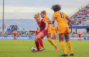 Sophomore Leah Pruitt turns into double coverage against West Virginia on Sunday. Pruitt assisted senior Katie Johnson in the game-winning goal in the 75th minute. - Photo courtesy Madeleine Roche