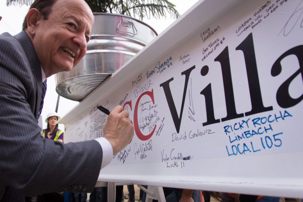 Daily Trojan File Photo To new heights · Nikias signs the commemorative beam at the halfway mark for the USC Village in January during the spire ceremony. 
