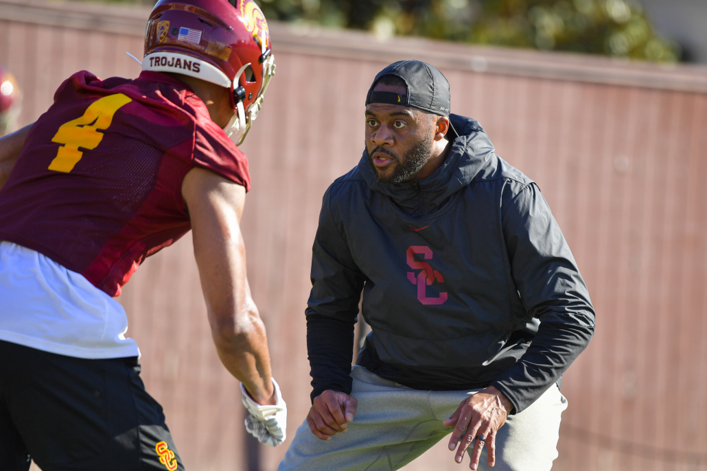 USC wide receiver coach Keary Colbert in a drill with a player in practice.