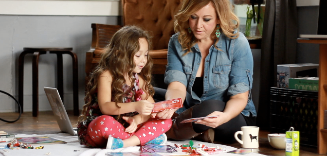 Jennifer with her daughter Charlotte playing a boardgames