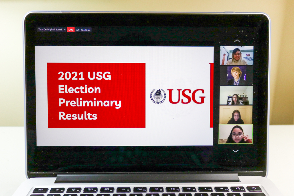 Laptop open to Zoom call. Screen says "2021 USG Election Preliminary Results." 