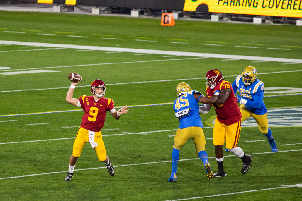 Kedon Slovis holding a ball in his right hand in a game against UCLA.