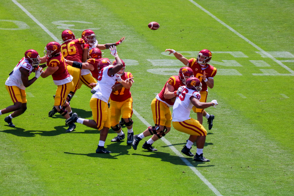 Kedon Slovis throws over a defensive line closing in on the pocket. 