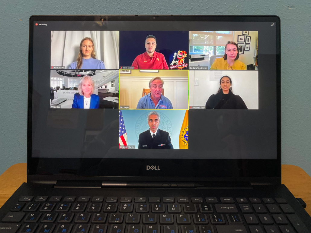 A photo of a laptop displaying seven people on a Zoom call. 