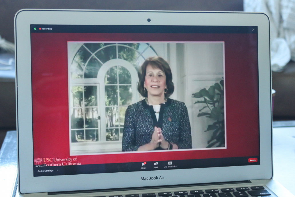 Laptop screen open to Zoom webinar event, with Carol Folt on screen. 