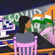 An animation of a girl sitting on a pink chair in front of her desktop, typing on her keyboard. The screen flashes covid 19, flag and map of India and the world globe.