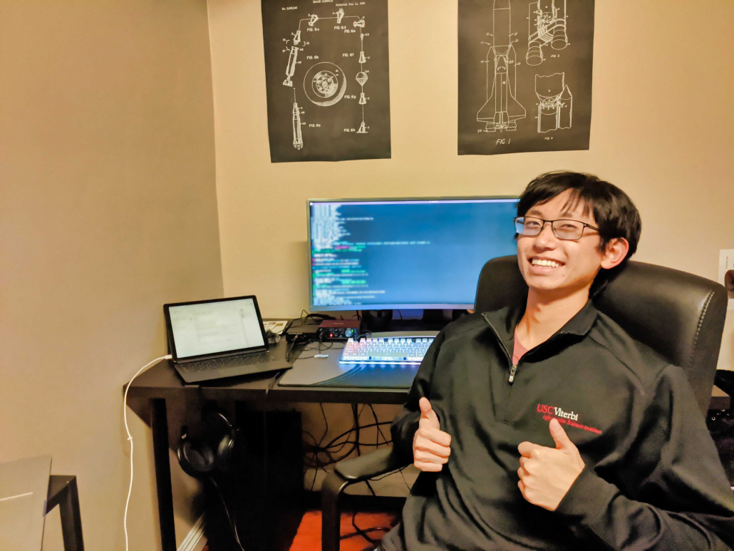 Photo of Haoda "Harry" Wang sitting in front of a computer. 