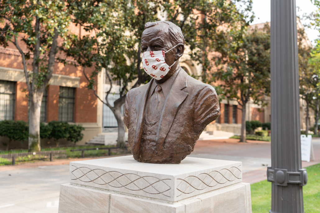 A statue on campus wearing a USC mask. 