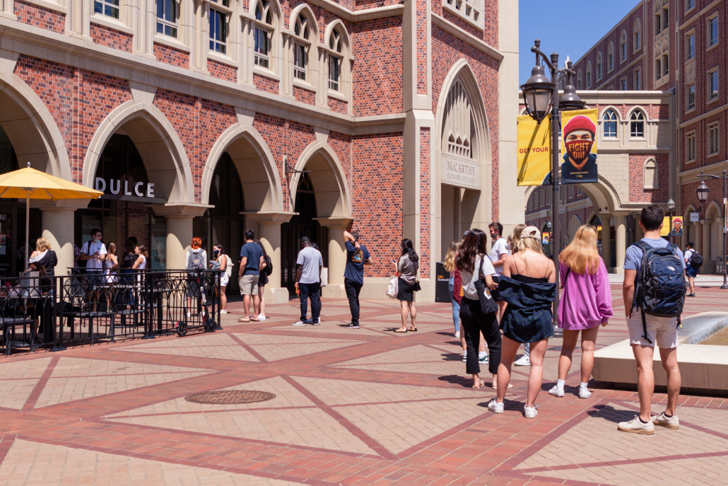 Students wait in a line to enter Dulce in the USC Village.