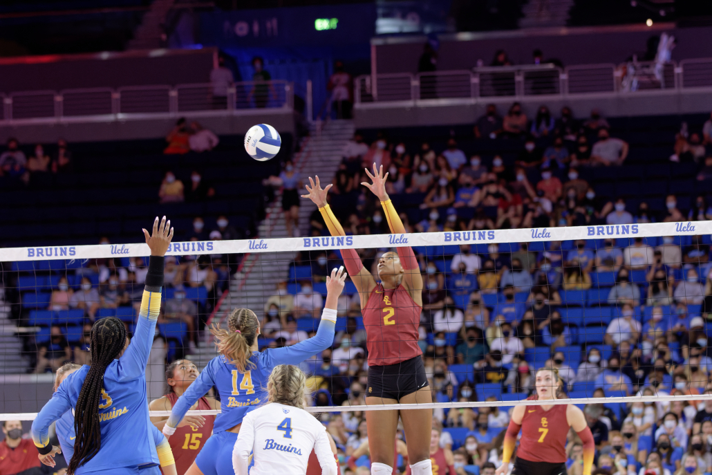Graduate student middle blocker Candice Denny attempts to block the ball from reaching over the net.