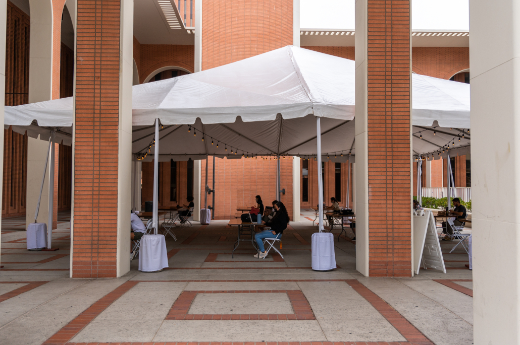 Students sit at an outdoor study space at the Center for International and Public Affairs.