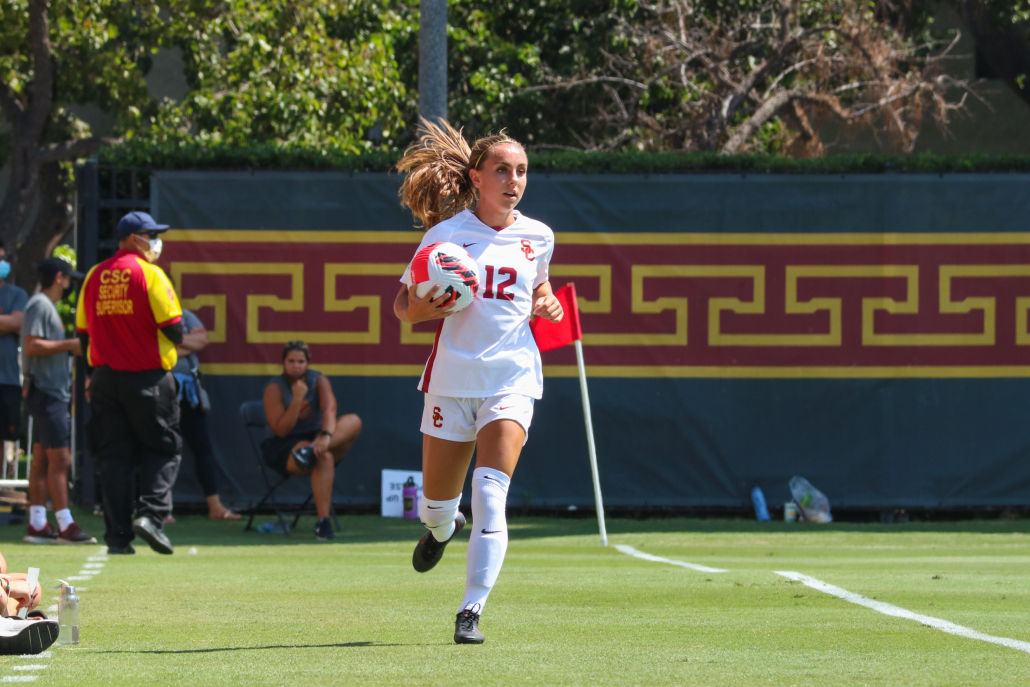 Sophomore defender Zoe Burns carries the ball on the sideline to get ready for a throw-in.