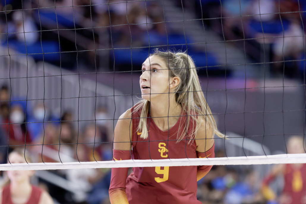 Graduate student outside hitter Paige Hammonds stands with the net in from of her looking up.