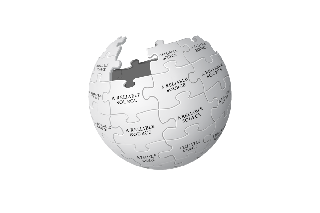 A drawing of the Wikipedia logo — a sphere made of jigsaw puzzle pieces. The puzzle pieces say "A reliable source." 