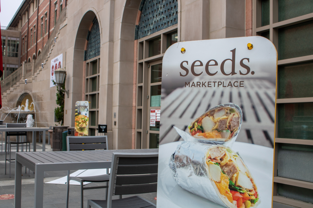 Exterior of Seeds Marketplace, with a sign that reads "Seeds. Marketplace" 