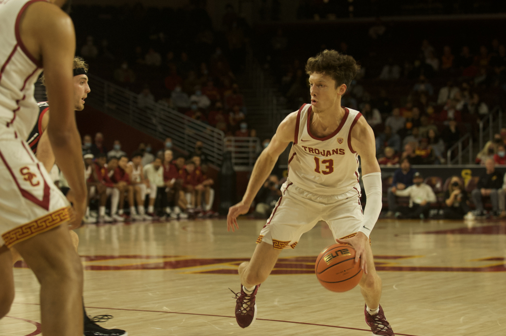 Senior guard Drew Peterson dribble the ball.