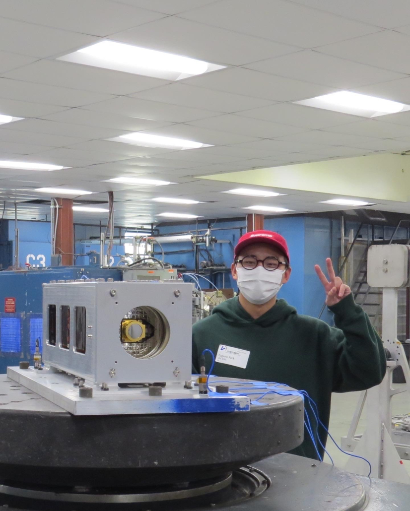 Photo of someone making the peace sign in a lab.