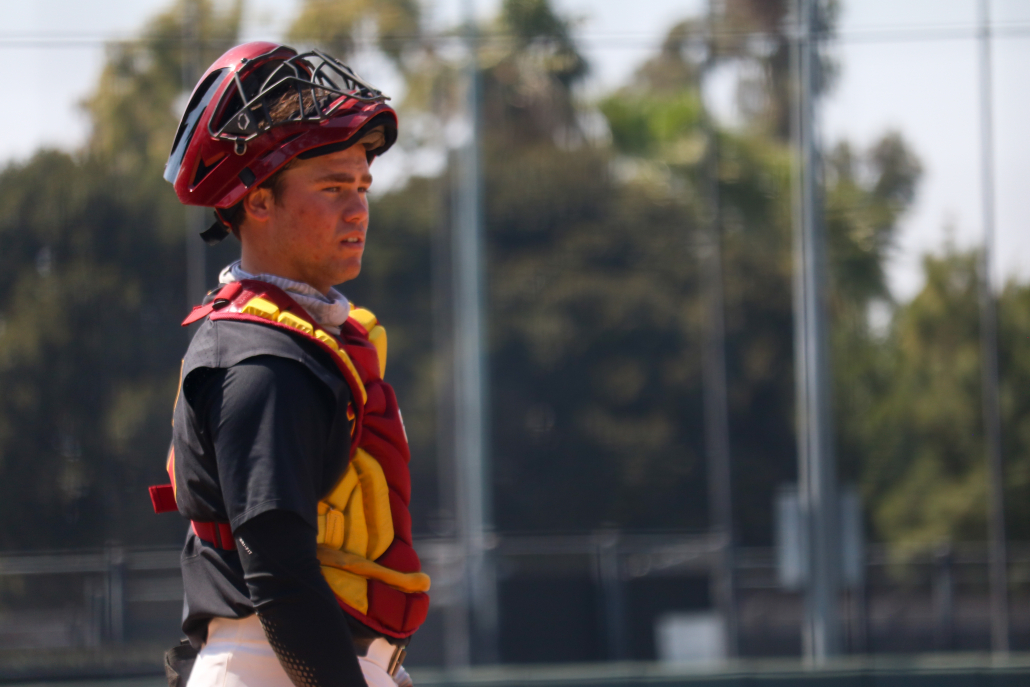 Sophomore catcher Garret Guillemette stares across the diamond with his mask resting on his head.