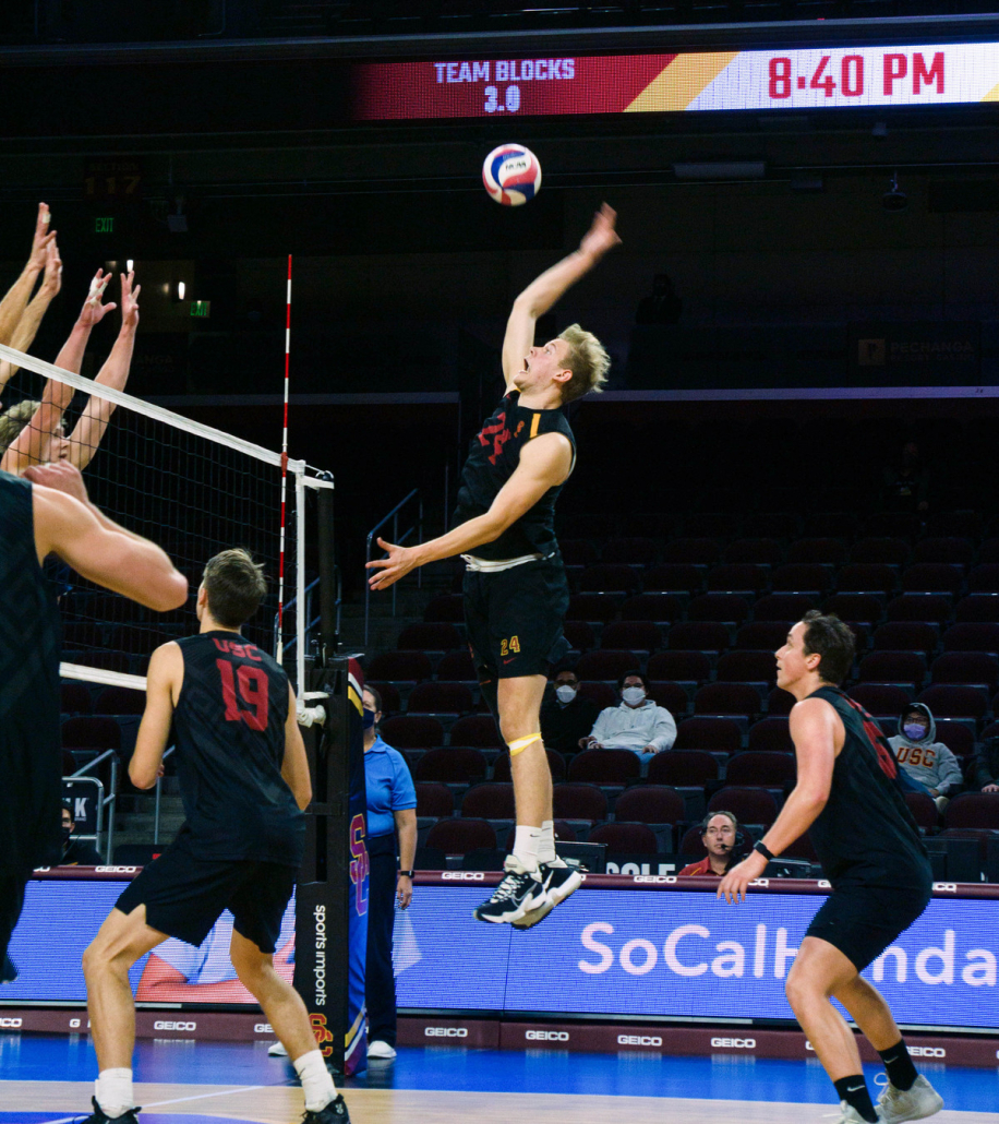 A USC Volleyball player jumping mid-air about to spike the ball.