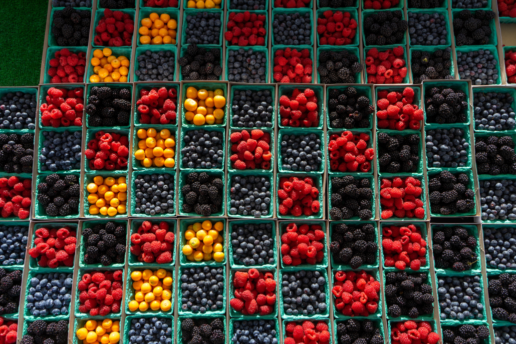 Photo of a grid of strawberries, raspberries, blueberries and golden berries.