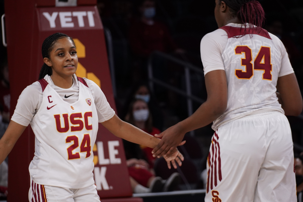 Senior guard Desiree Caldwell gives a high five during USC’s 68-58 loss against UCLA last Sunday. 