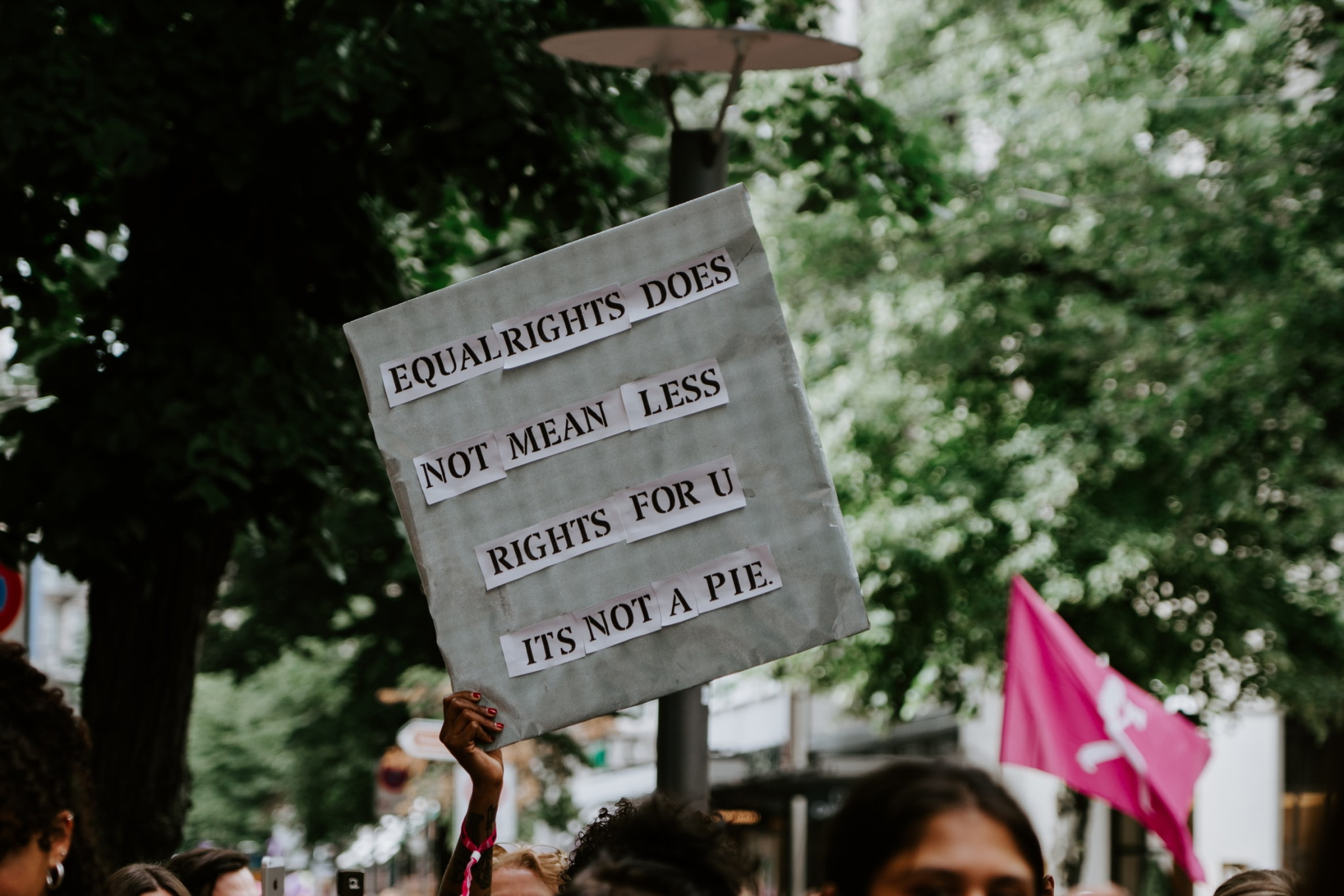 Stock photo of a protester holding up a sign that says, 