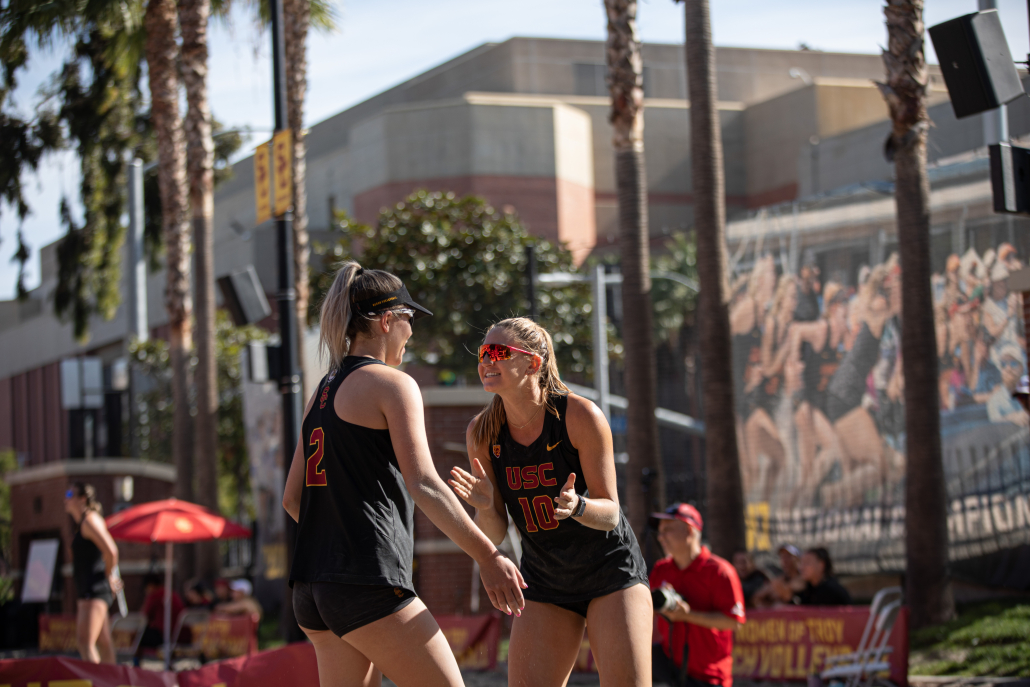 USC beach volleyball women team number two and number ten hyping each other. 